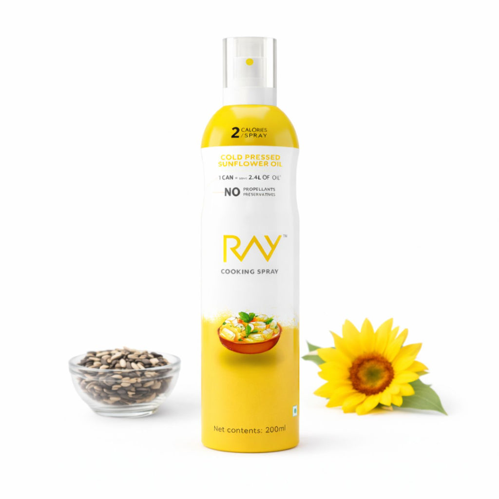 Ray cooking spray bottle with sunflower, seeds, and bowl on a white background